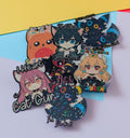 Set of colorful anime-style character pins on a yellow and white background
