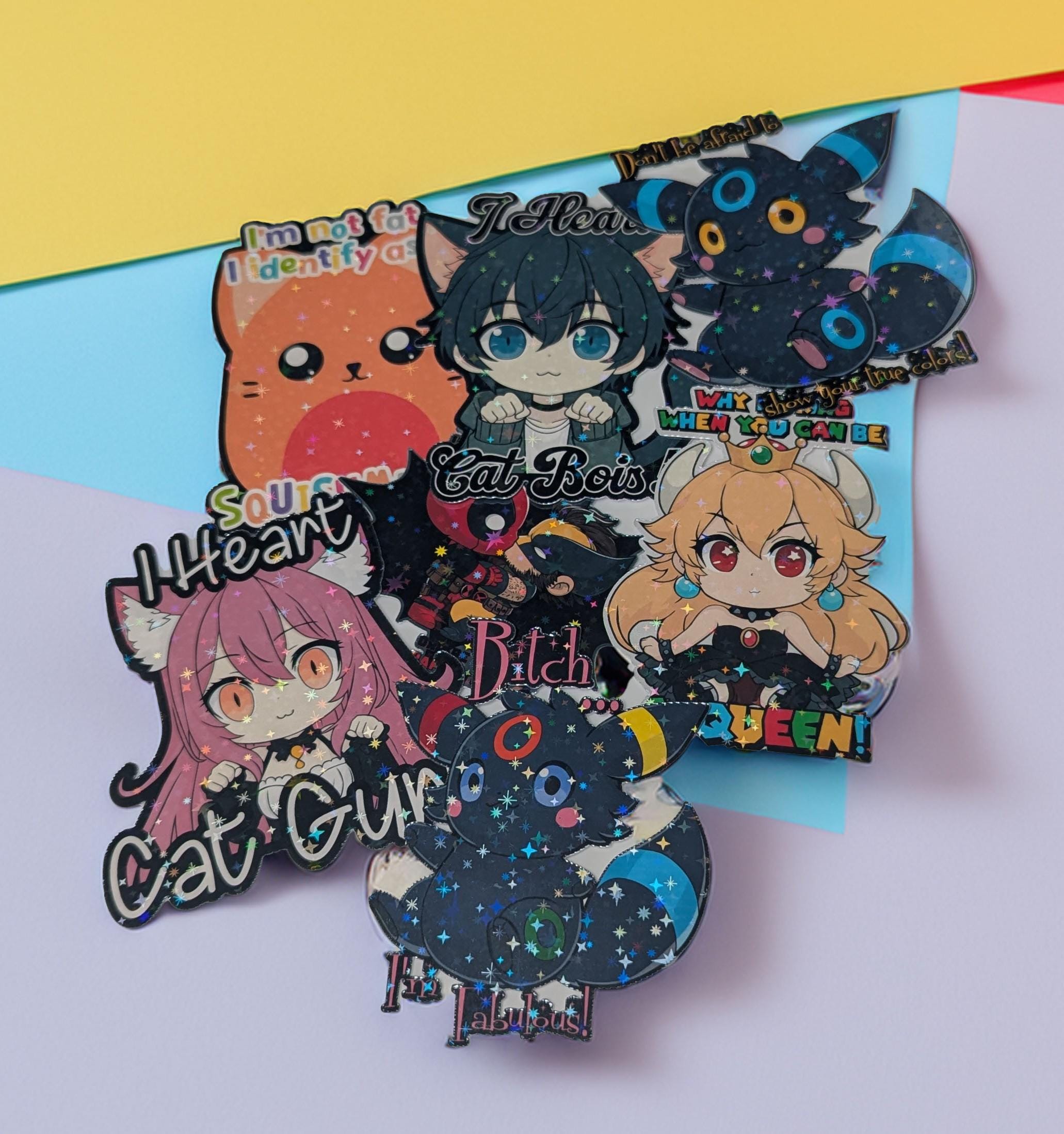 Set of colorful anime-style character pins on a yellow and white background