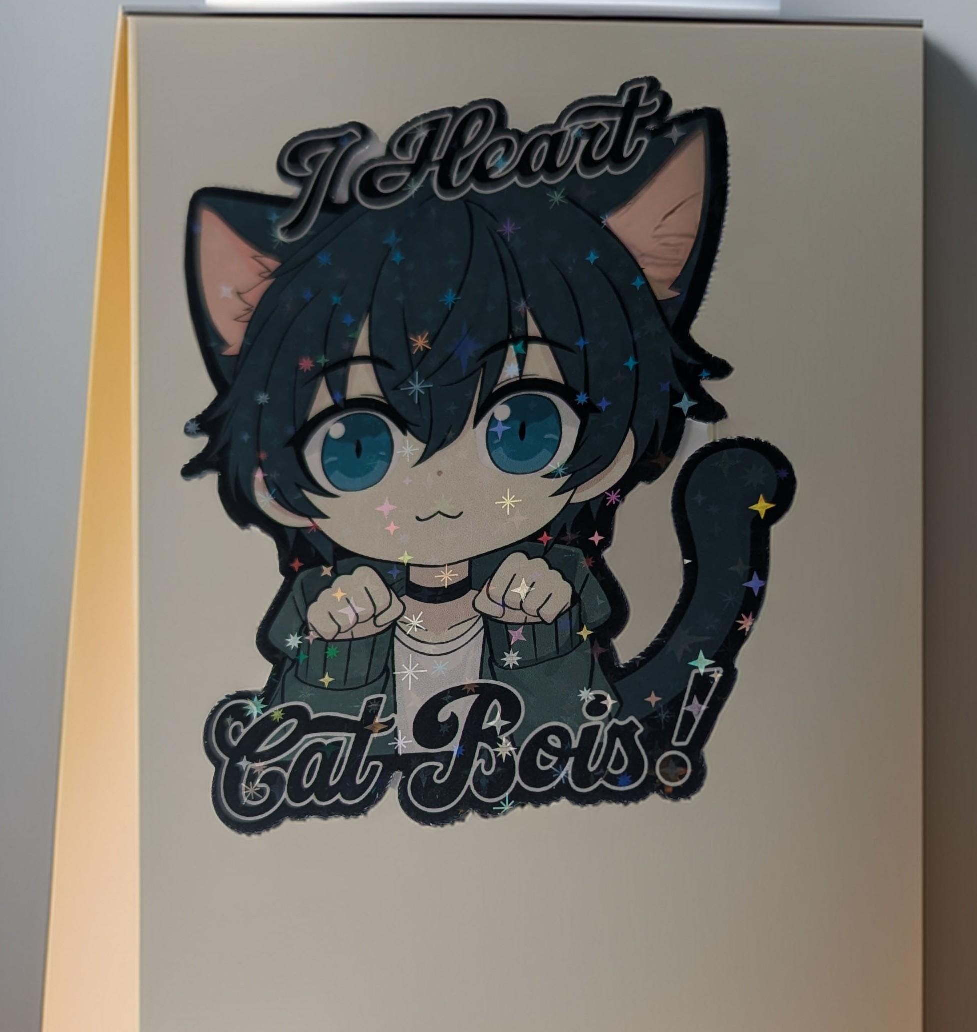 Card with a cute illustration of a cat-like character and text 'I Heart Cat Boys!' on a plain background.